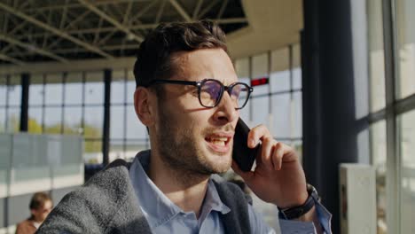 hombre hablando por teléfono en el aeropuerto