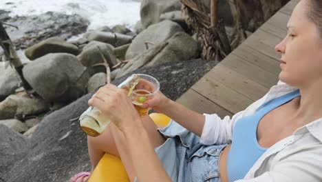 woman enjoying beer on the beach