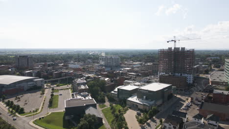 Vibrant-industrial-urban-scene-growing-with-building-construction,-aerial