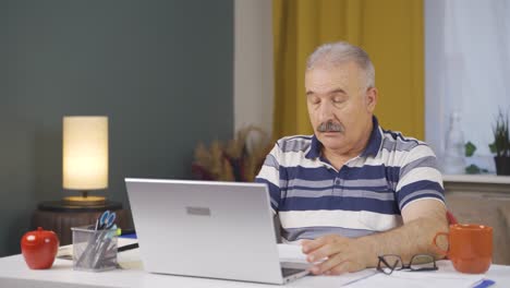 Home office worker old man depressed and unhappy.