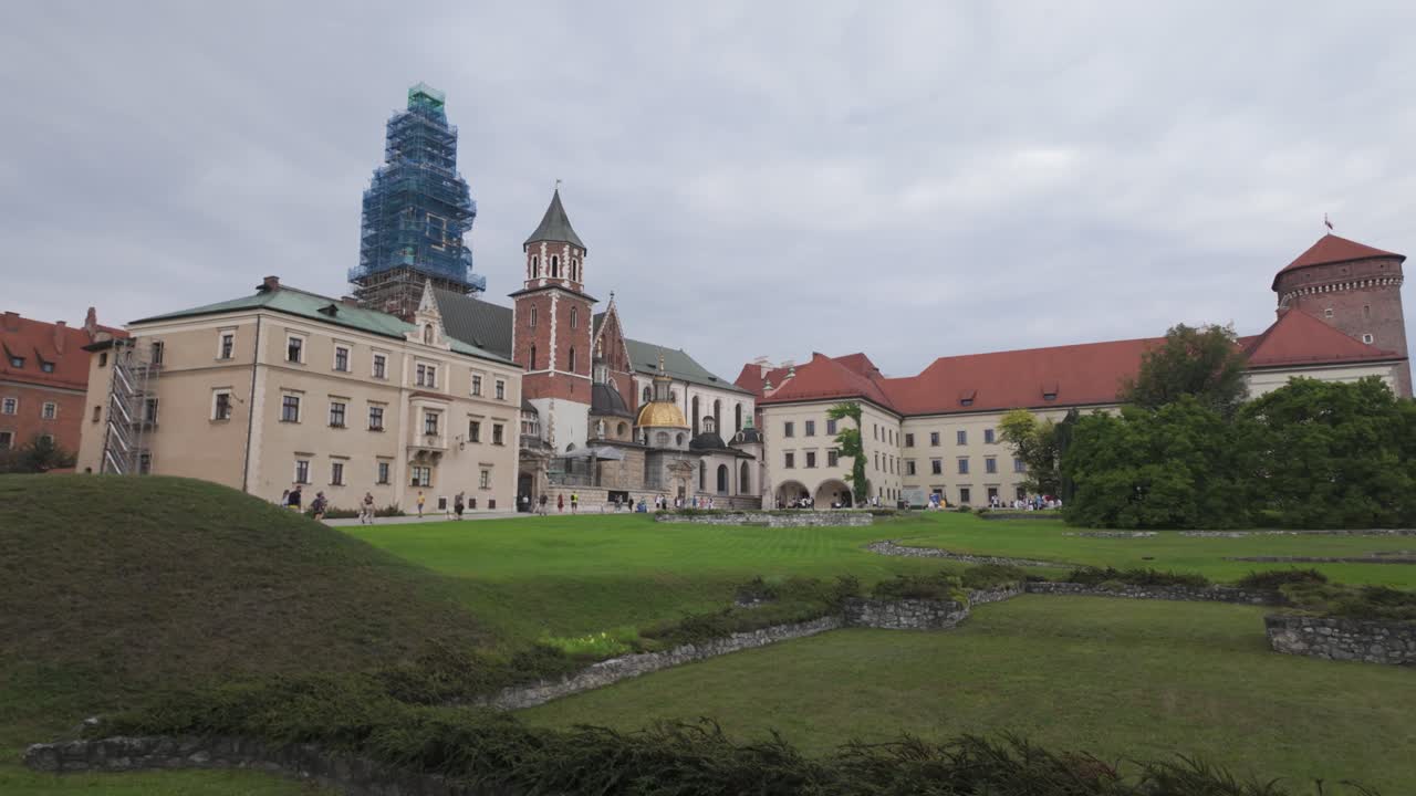 Wawel Cathedral with lush green surroundings on a cloudy day in Krakow