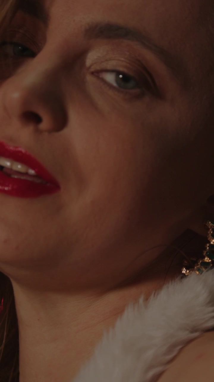 Beautiful vertical portrait of a beautiful blonde woman looking up at the camera in slow motion
