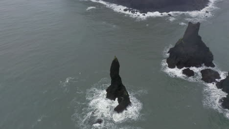 Aerial:-Close-up-shot-of-Reynisdrangar-sea-stacks-during-bad-weather