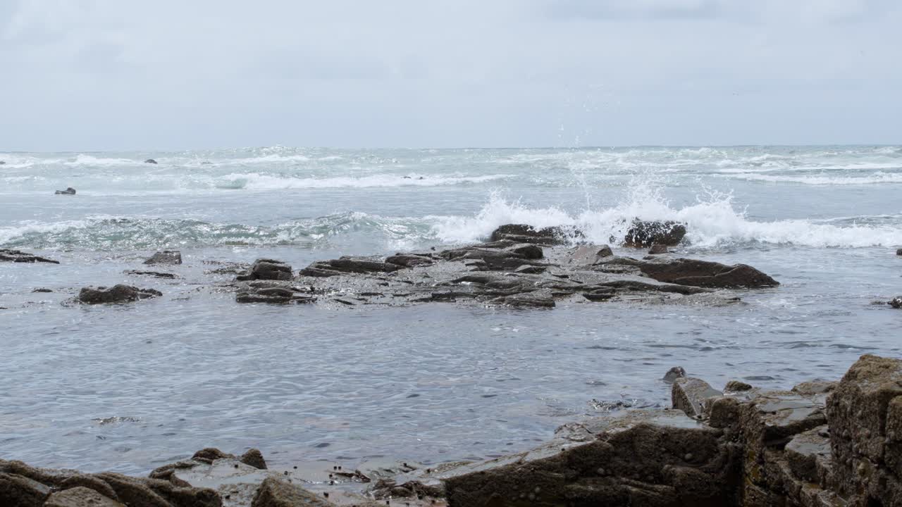 Beautiful coastal landscape showcasing rocky shorelines and gentle waves on a cloudy day