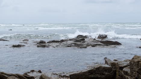beautiful coastal landscape showcasing rocky shorelines and gentle waves on a cloudy day