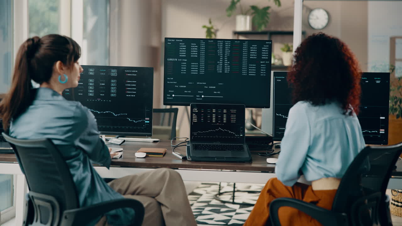 Businesswomen Analyzing Stock Market Data in the Office