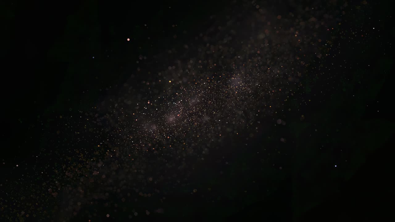 Rising diagonal gold dust cloud joining and glinting as light casting black void, forming two cores