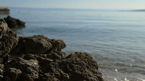 Man-grabbing-snorkel-mask-with-sea-view-background,-vacation-moment-close-up