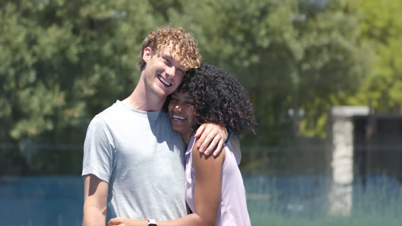Couple, man reaching out and showing affection to woman on blue court holding paddle and ball