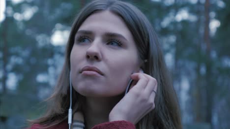 woman listening to music in the forest