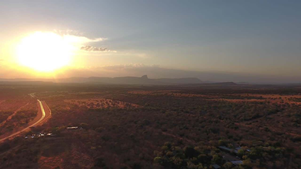 Explosion of light as the sun sets behind cloud - Hanglip mountain in Sterkrivier South Africa. Beautiful country side road on the left driving into the sunset.