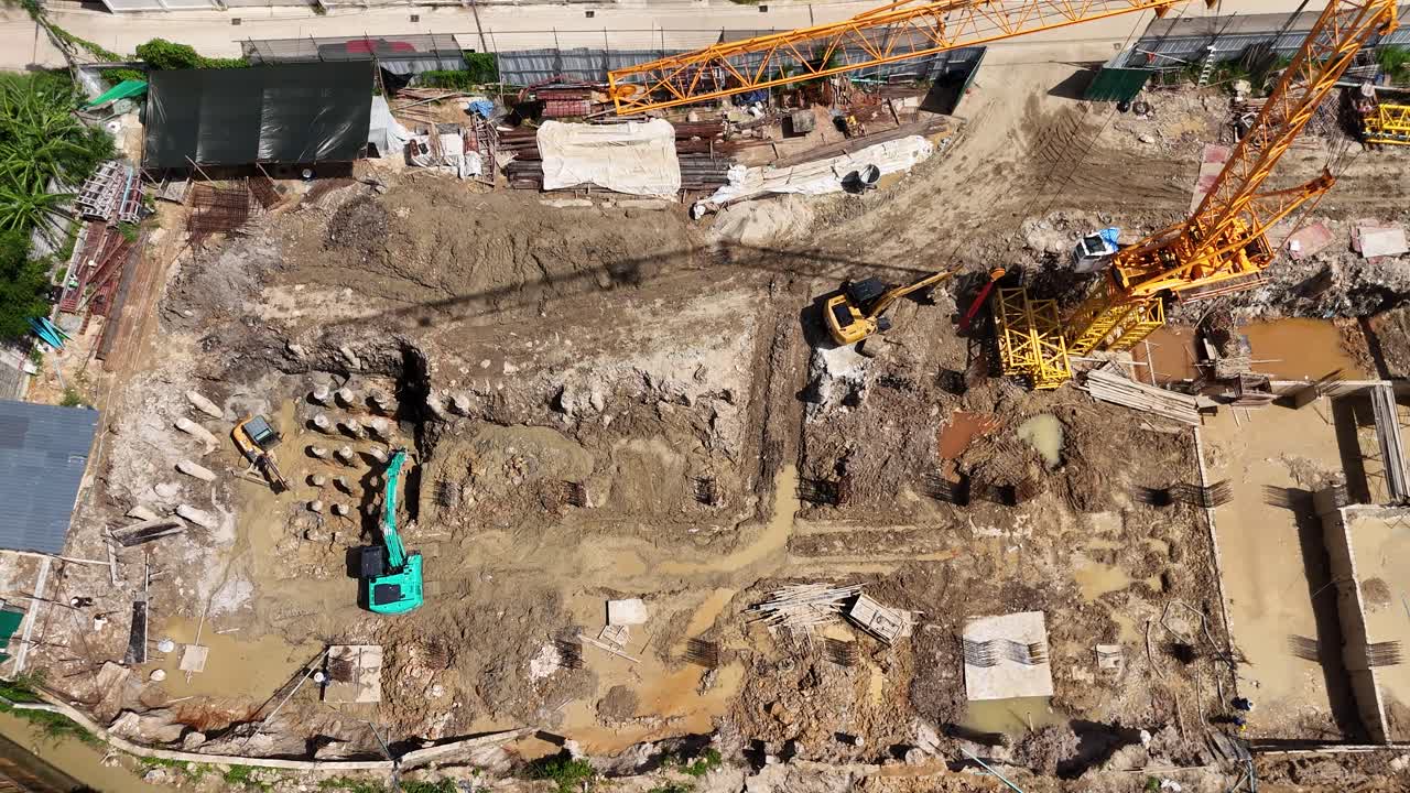 Aerial View of a Large Construction Site with Cranes and Excavators