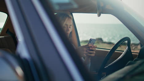 una mujer conduciendo un coche de época.