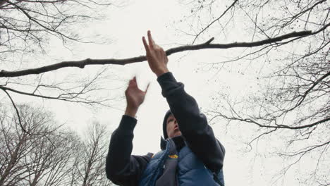 child playing with a stick in a forest