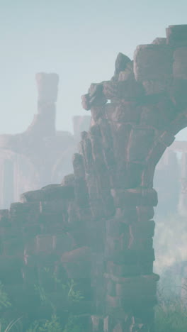 ruins of a stone archway in a foggy landscape