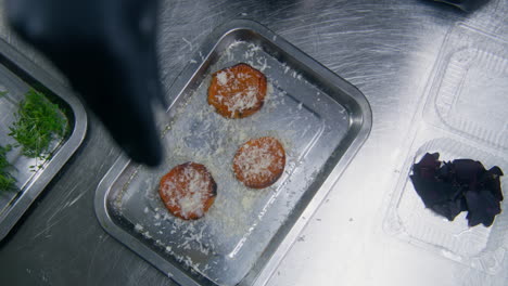 High-Angle-of-the-Cook-Sprinkling-Grated-Cheese-on-Baked-Sweet-Potato