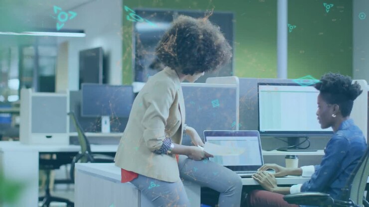 Animation of network of qr codes over african american businesswomen using laptop in office