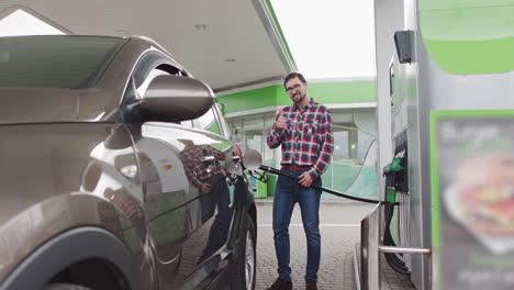 Man Filling Up Car at a Gas Station