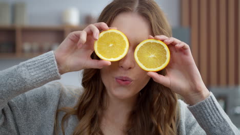 woman making faces with oranges