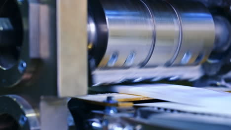 the big drum rotates in close-up.. the outer layer of diapers is made on the machine.
