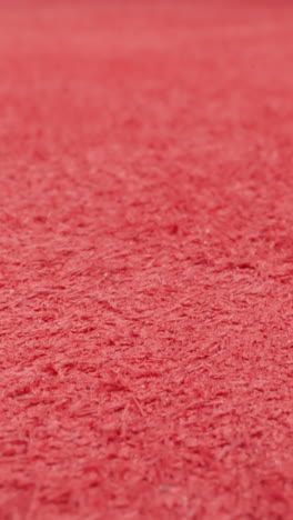 textured surface of red cow leather material as background extreme close view. sewing clothes and shoes in workshop. design ideas and fashion