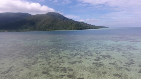 Drone-camera-moving-forward-or-dolly-in-over-beautiful-beach-at-Karimun-Jawa-island