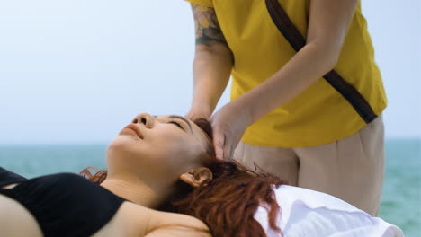 masseuse giving massage to woman