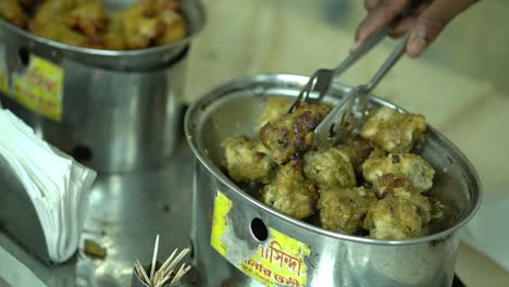 Close-up-shot-of-a-hand-serving-spicy-kebab-in-an-Indian-wedding