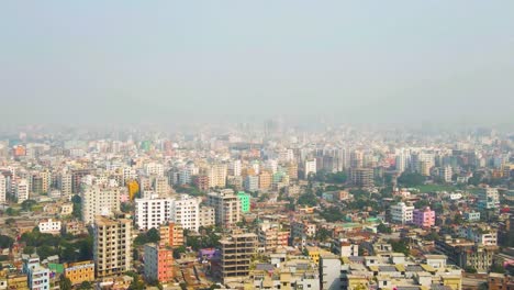 aerial view of dhaka, bangladesh. residential buildings, polluted air above city on sunny morning, drone shot
