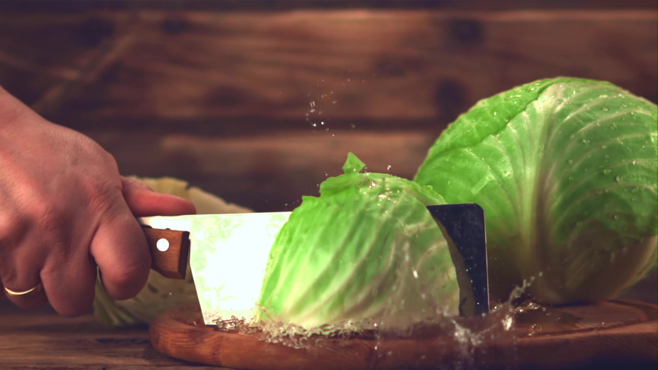 Slow Motion of Fresh Cabbage Being Cut with a Knife