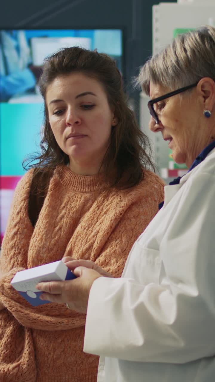 Vertical video: Pharmacist talking to client about supplements and pills