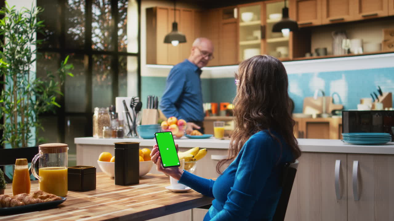 Mockup display on phone at kitchen table with elderly woman smiling