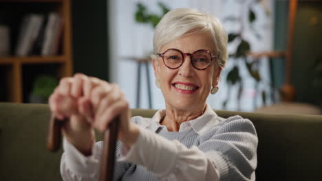 portrait of a smiling elderly woman with a cane