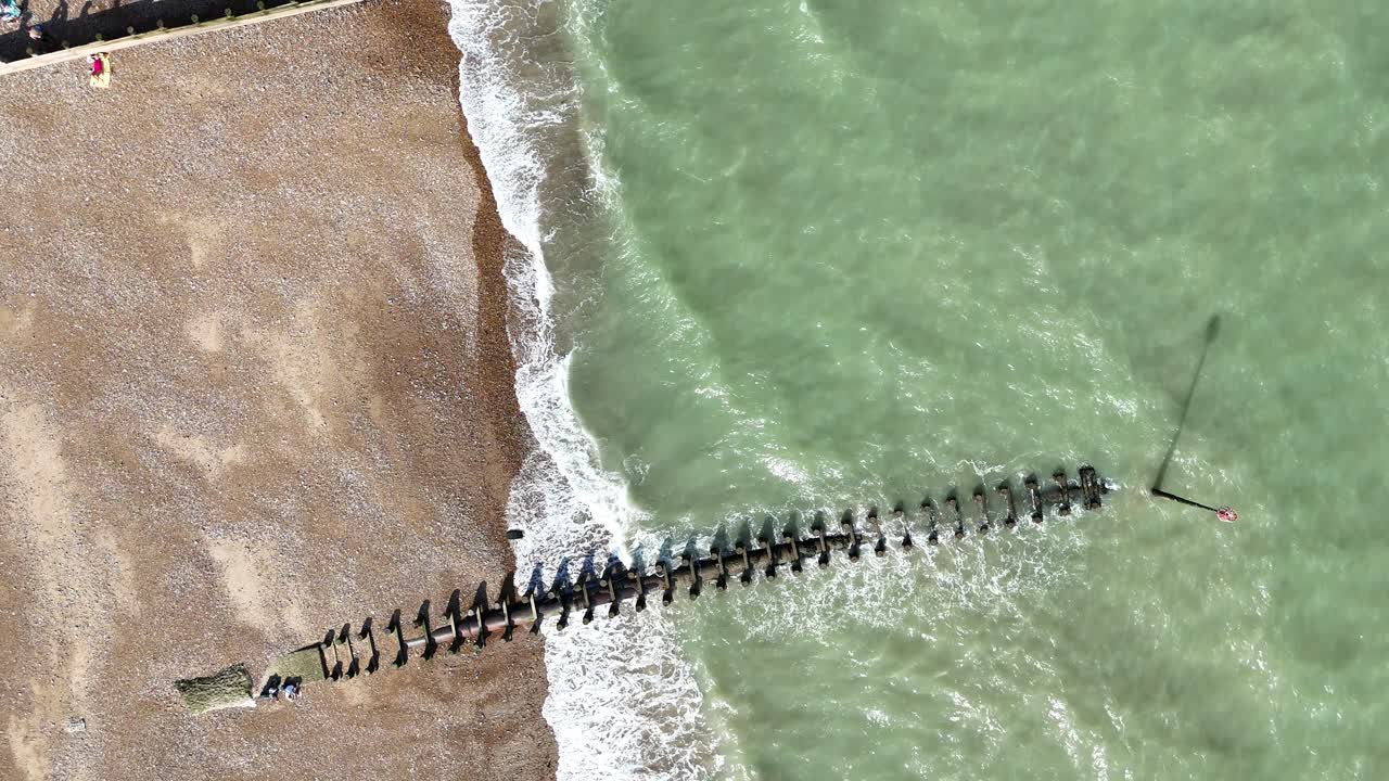 Overhead birds eye drone aerial view Eastbourne UK Beach and groynes