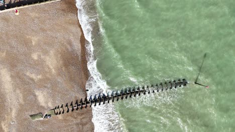 overhead birds eye drone aerial view eastbourne uk beach and groynes