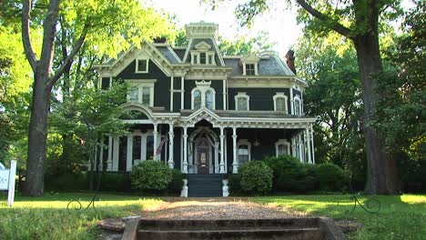 a lovely old house is surrounded by large leafy green trees