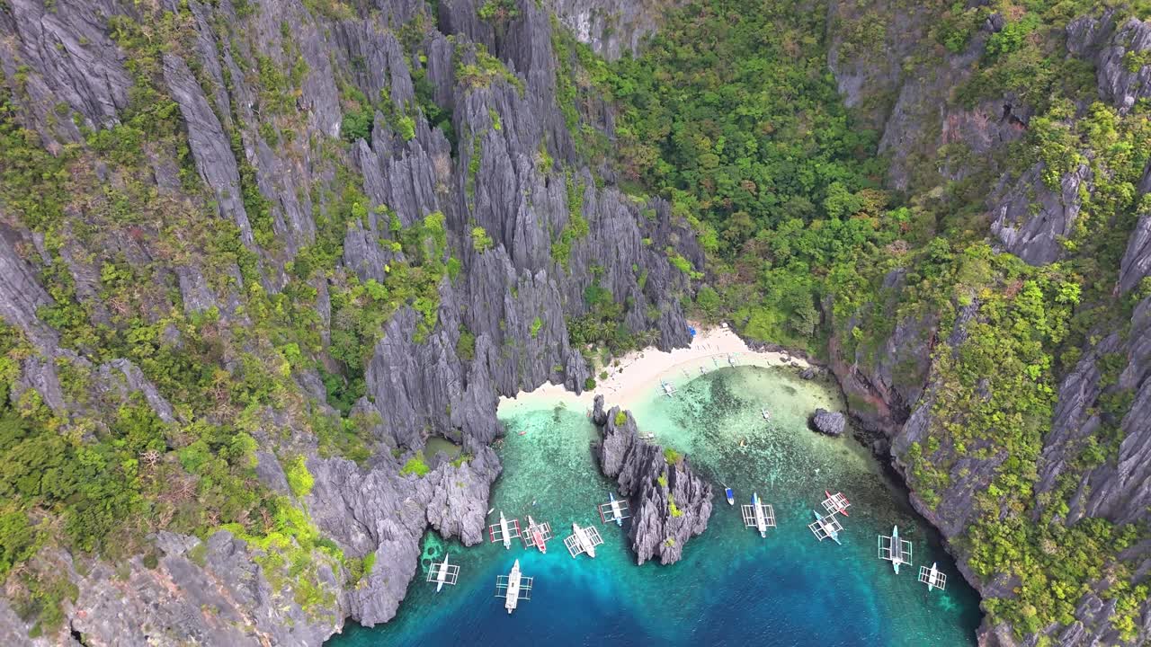 Stunning top view of boats at Secret Lagoon and Jiji's Beach, in Miniloc Island, Philippines