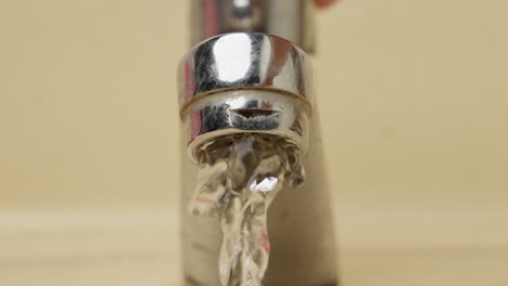 water spilling from an open faucet