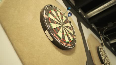 throwing darts at a dartboard - low angle shot