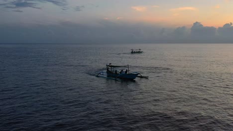aerial-of-tourists-on-a-jukung-boat-in-Lovina-Bali-Indonesia-searching-for-dolphins-at-sunrise
