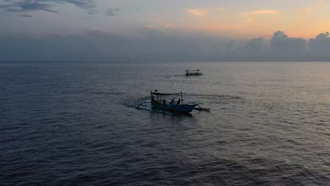 aerial of tourists on a jukung boat in lovina bali indonesia searching for dolphins at sunrise