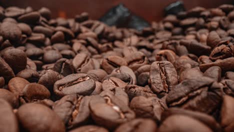 Close-up-of-seeds-of-coffee.-Fragrant-coffee-beans-are-roasted-smoke-comes-from-coffee-beans.