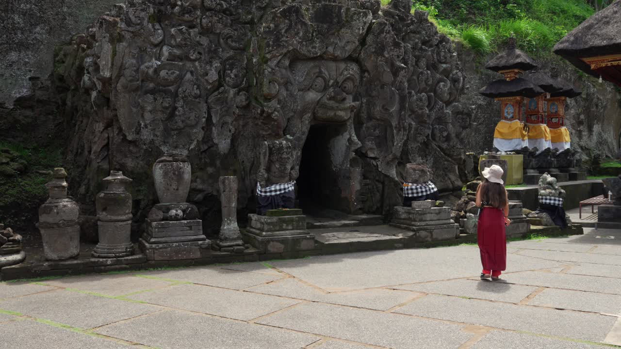 Goa Gajah demon face carved entrance into the rock doorway Hindu Buddhist religion Bali Indonesia