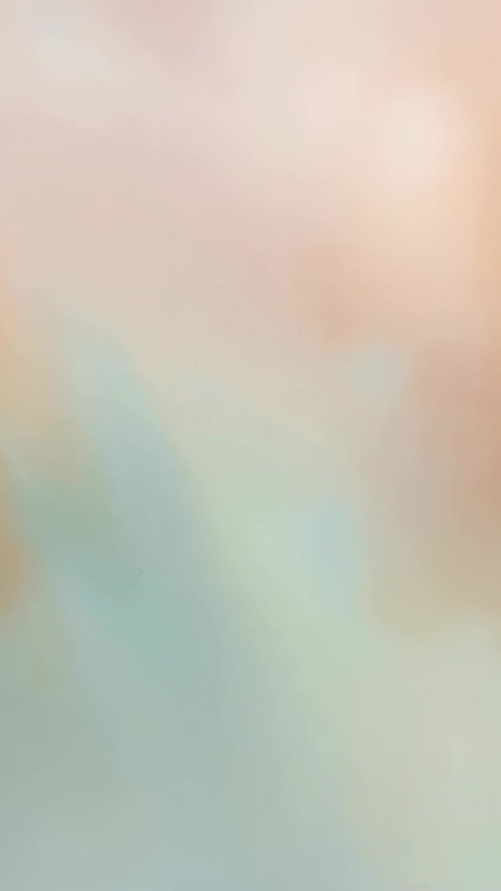 Vertical video: Shifting camera lens making pastel blur closeup interior with peach and aqua fields