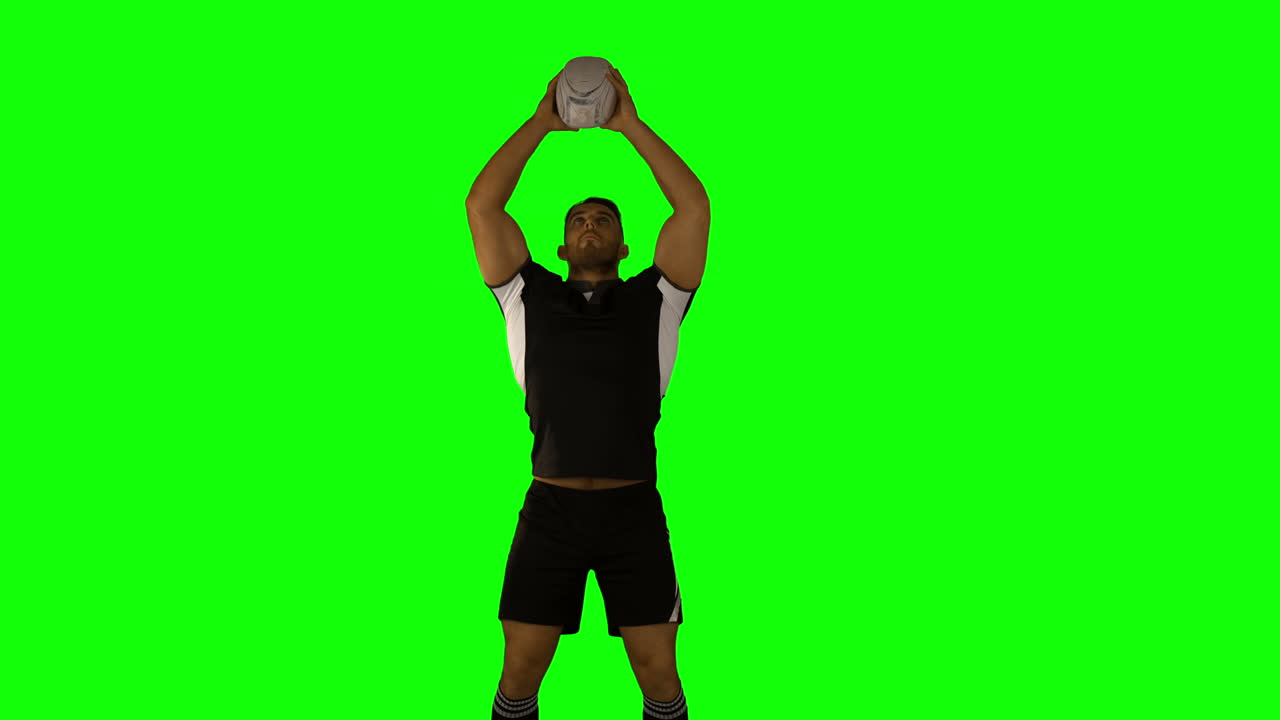 Serious rugby player catching ball 