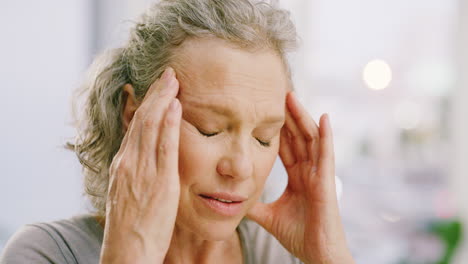 Senior-woman-with-headaches-rubbing-her-forehead