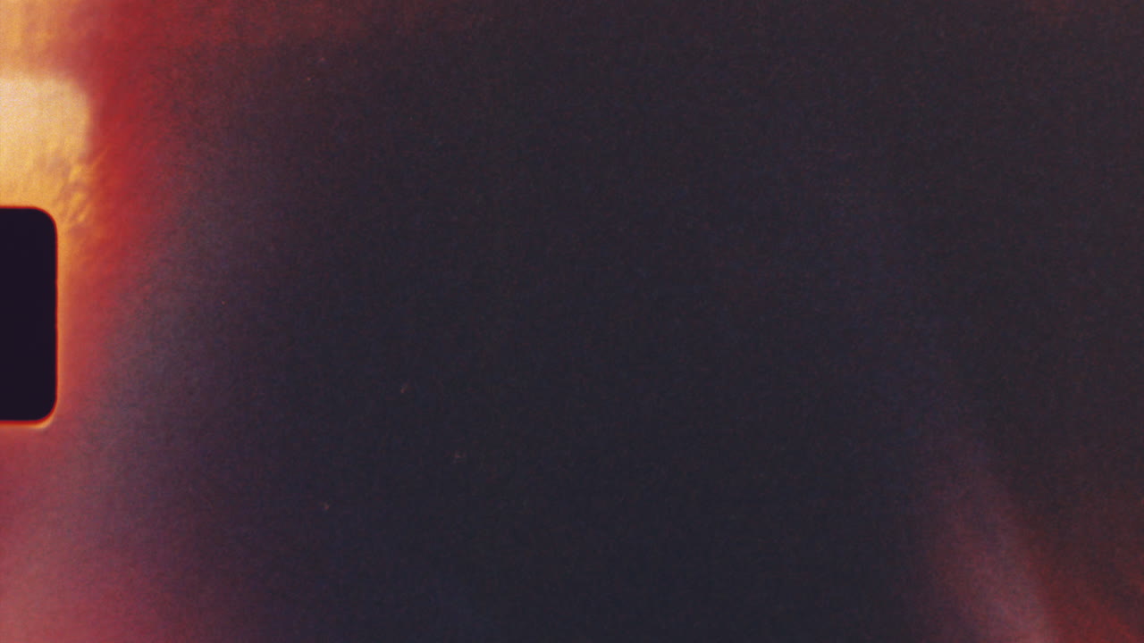 Grungy 8mm film strip with light leaks and scratches