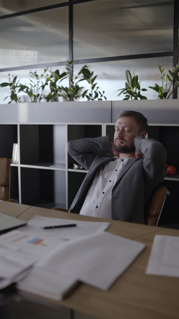 un hombre de negocios con dolor de cuello en su escritorio.