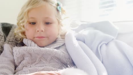 little girl sitting on sofa stroking her pet cat 4k 4k