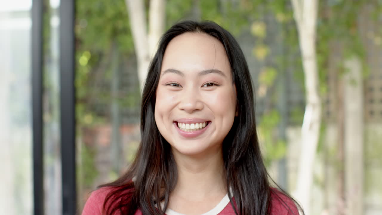 Smiling young woman posing outdoors, enjoying nature and fresh air